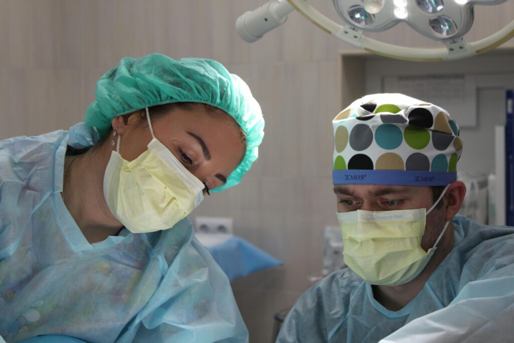 WhiteCoatChina Surgeons wearing masks and scrubs conduct an operation in a hospital setting.