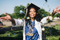 pexels photo 1139317 1139317 African American woman celebrating graduation with confetti outdoors, filled with happiness and success.